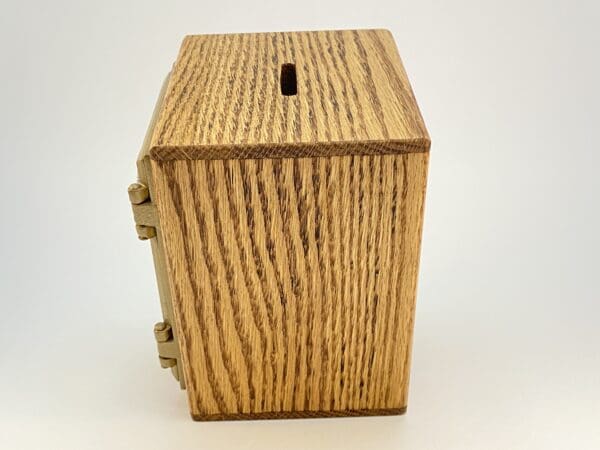 Wooden money box with metal hinges.