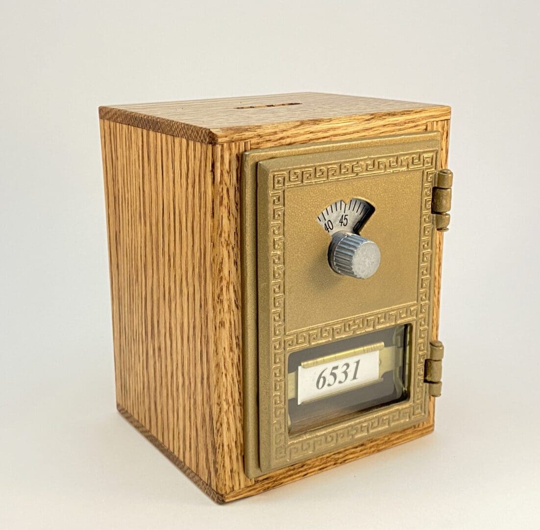 Vintage wooden lockbox with combination dial.