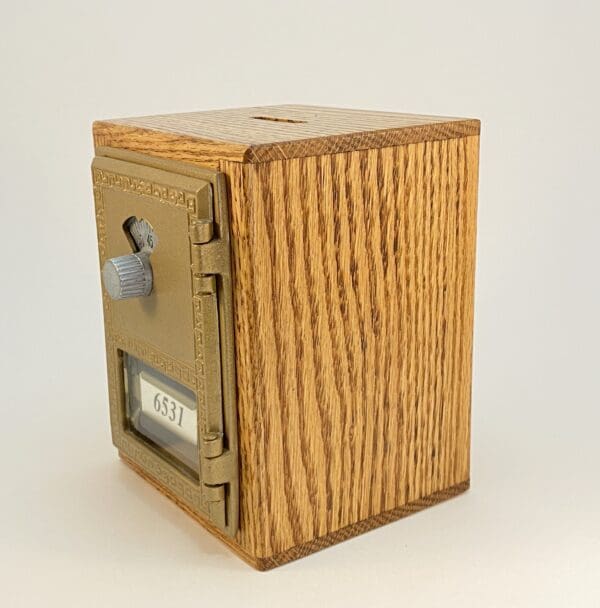 Vintage wooden safe with a metal lock.