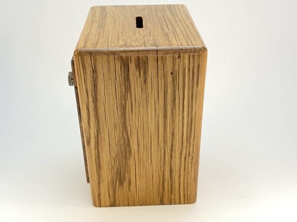 Wooden money box with a slot opening.