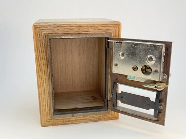 Wooden box with lock and open door.