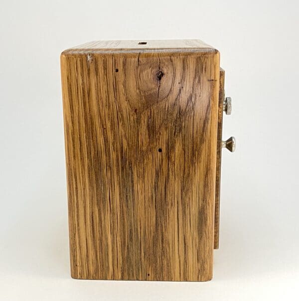 Wooden box with a small coin slot.