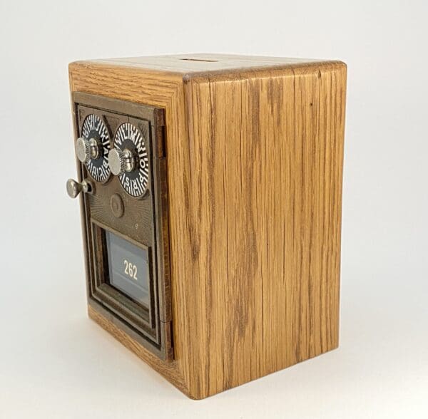 Vintage wooden box with dials and slot.