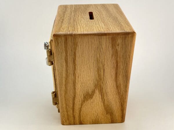 Wooden box with a coin slot on top.