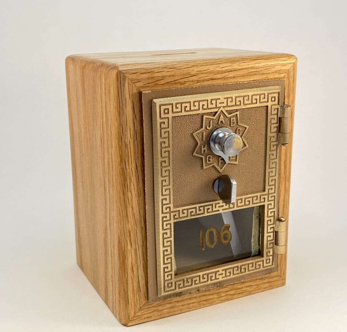 Wooden safe with ornate design and keyhole.