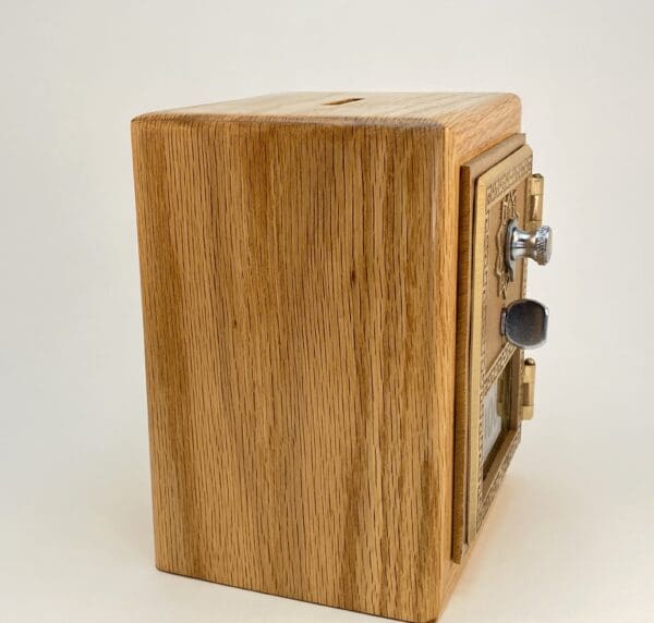 Wooden coin bank with lock and slot.