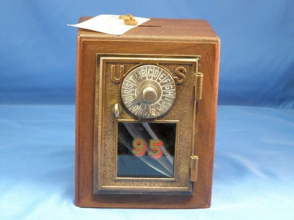 A small wooden box with a clock on top of it.