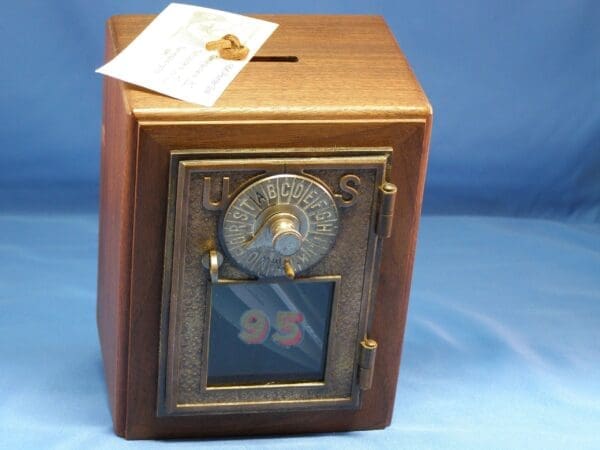 Antique wooden US mailbox with dial.