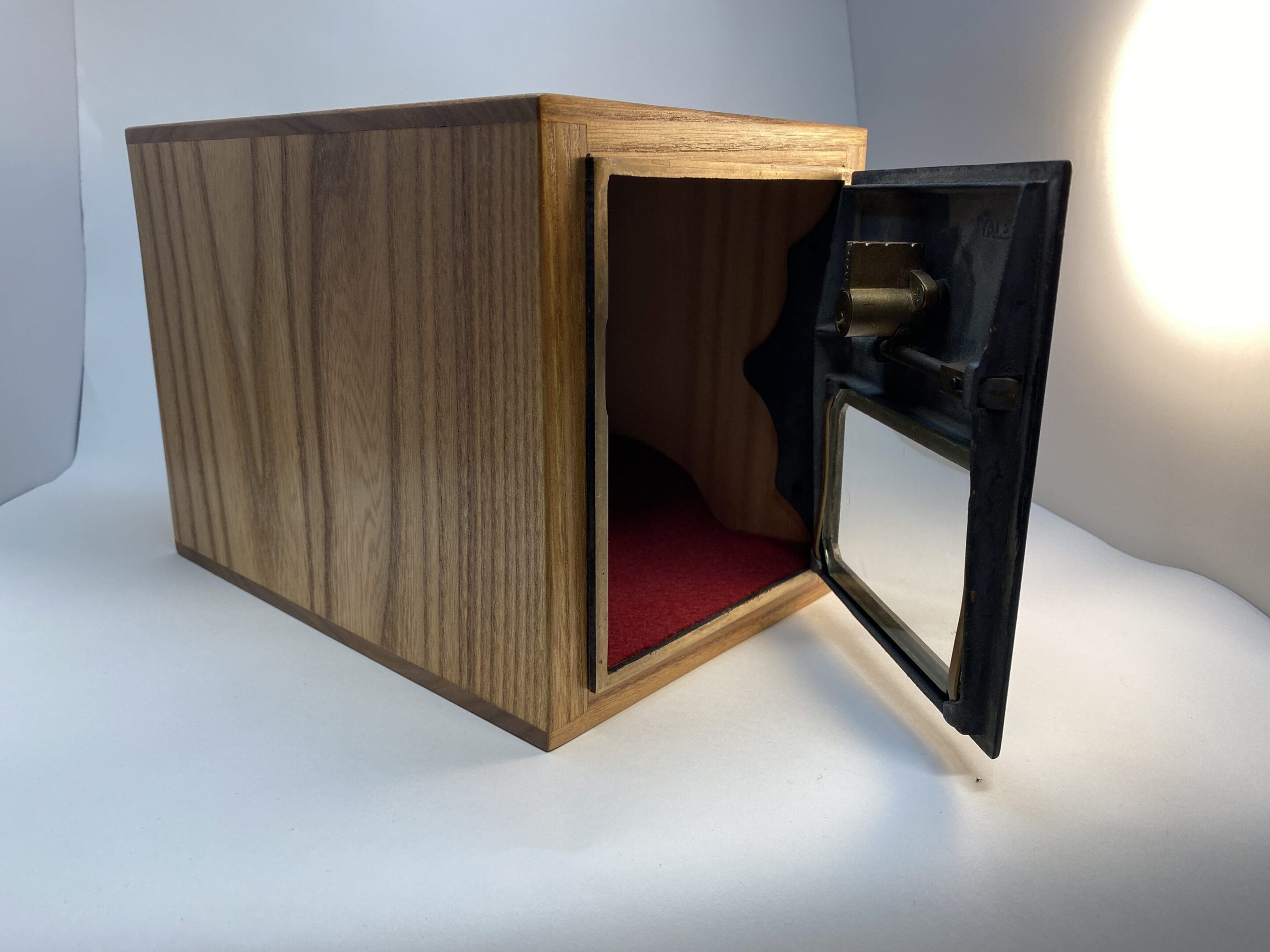 A wooden box with a glass door open.