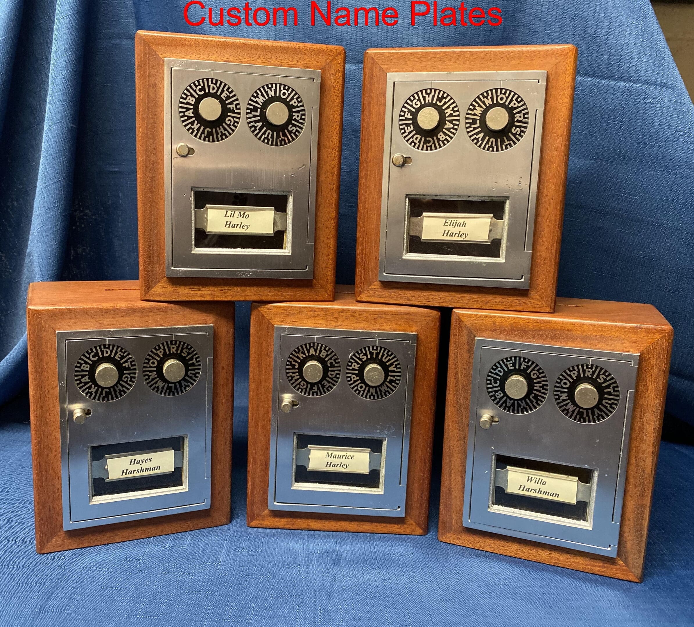 A group of five wooden boxes with metal faces.