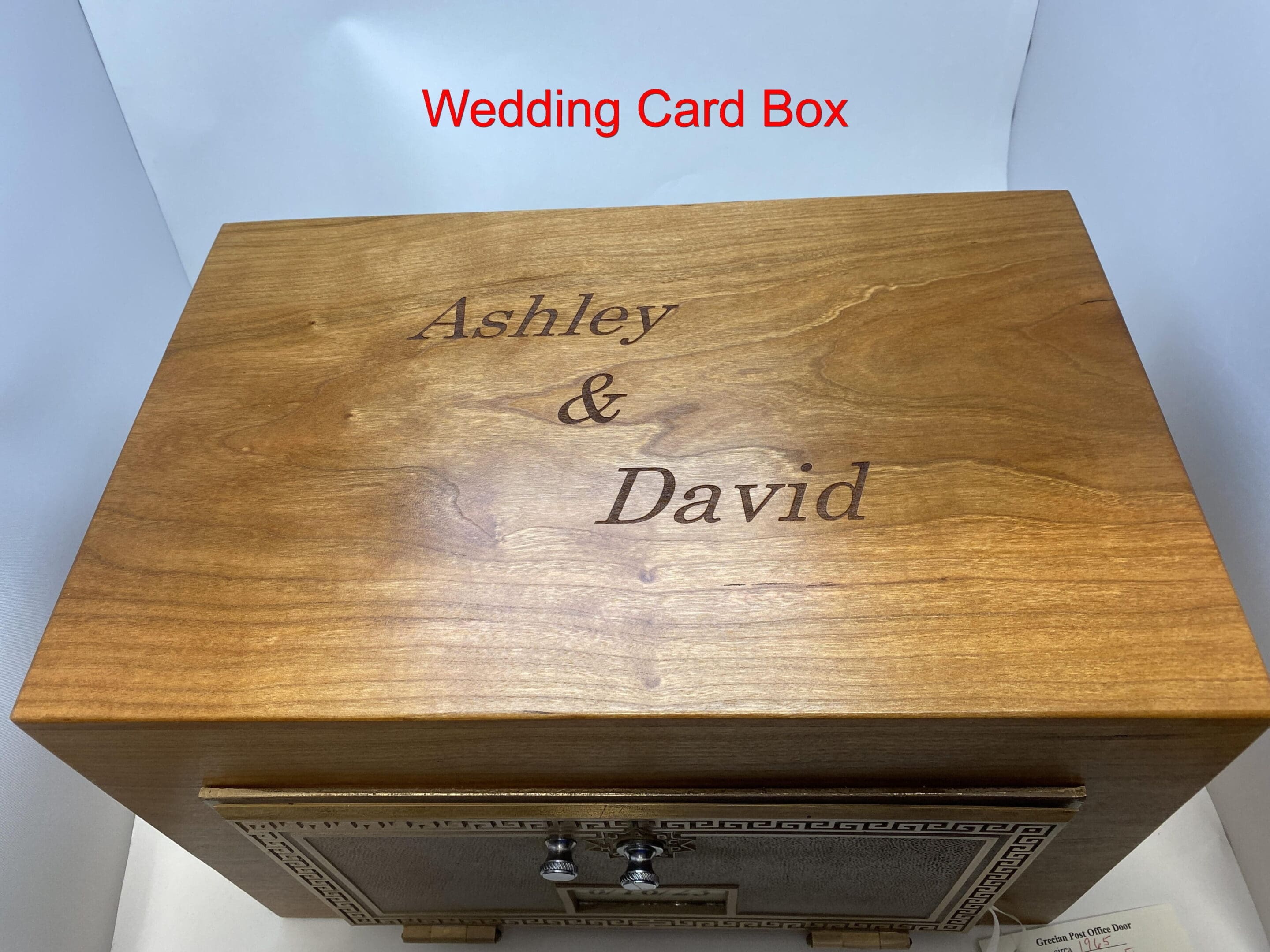 A wooden box with two names engraved on it.