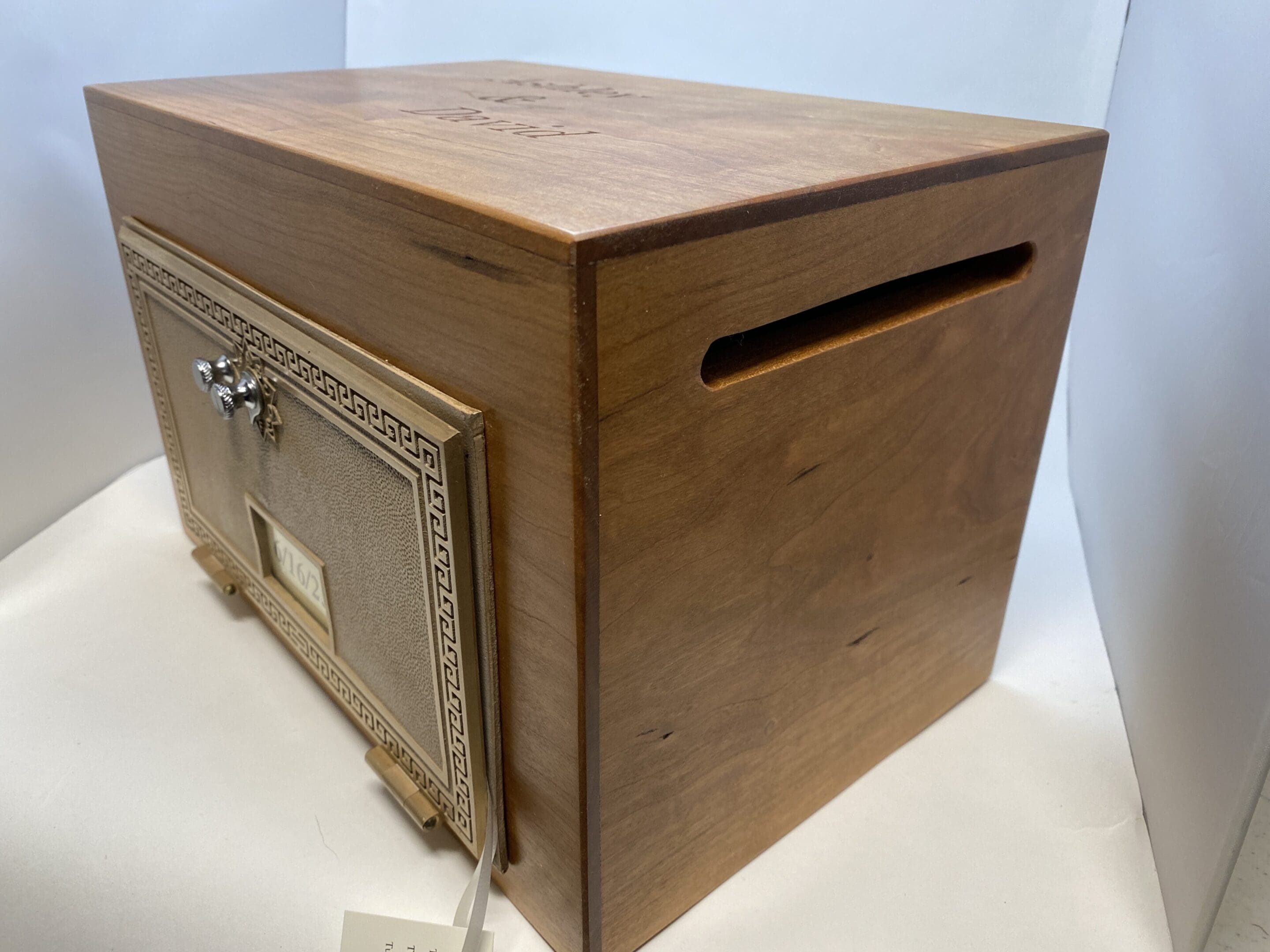 A wooden box with a metal door on top of it.