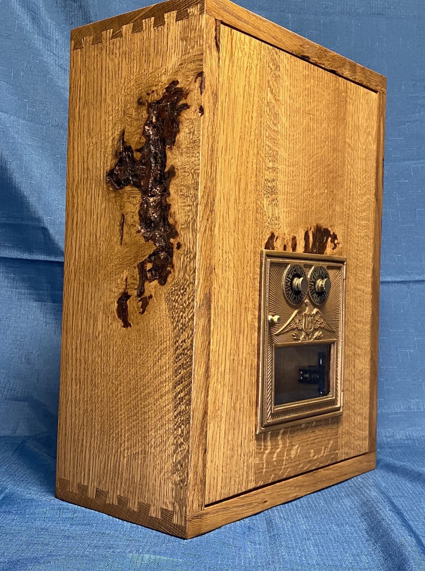 A wooden box with some metal door and a lock