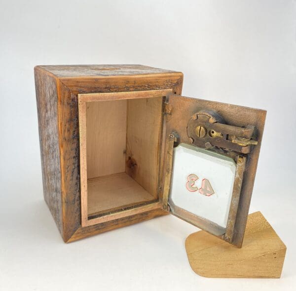 Wooden box with a hinged metal latch.